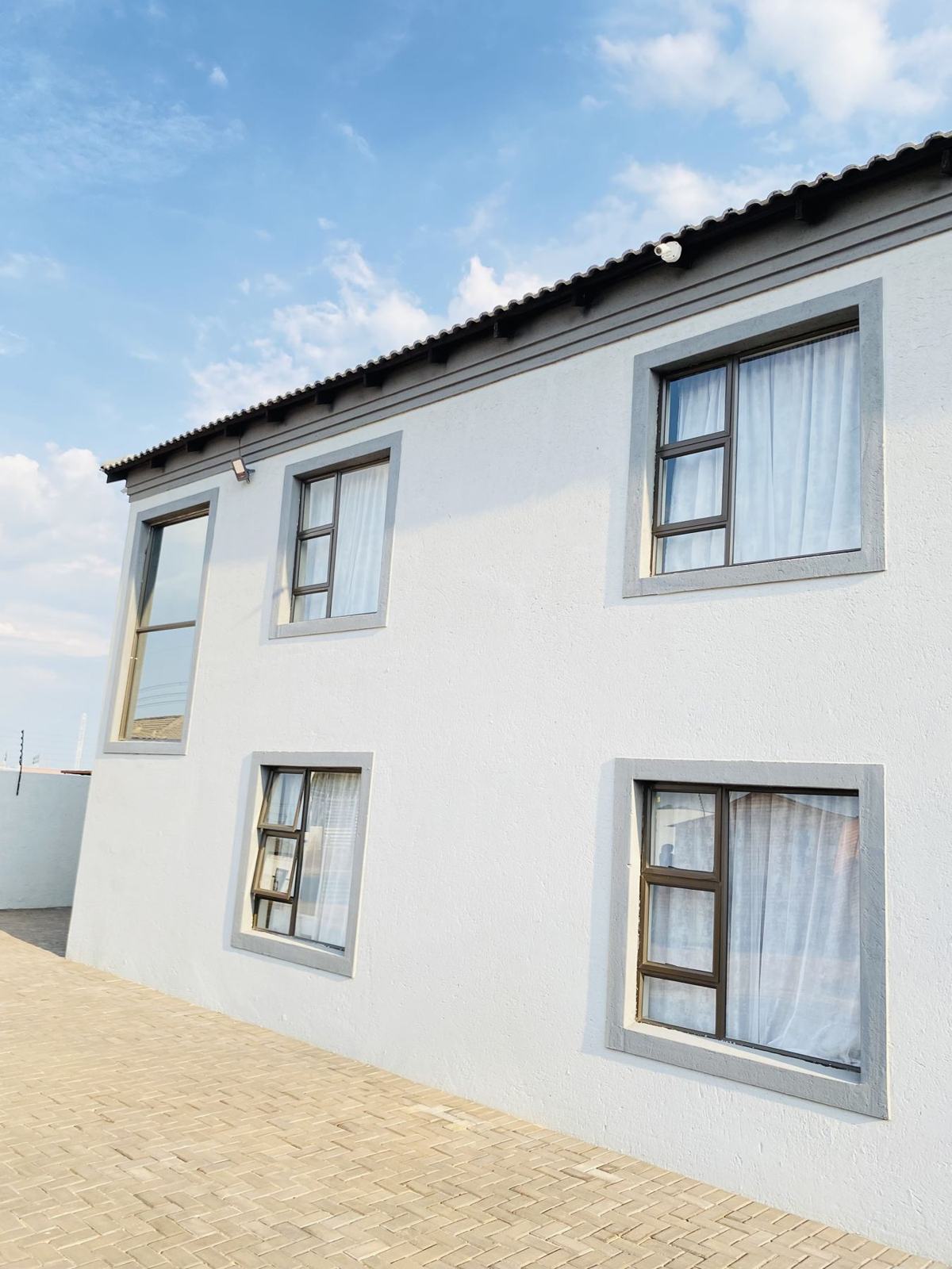 MMK Residence façade with charcoal-framed windows